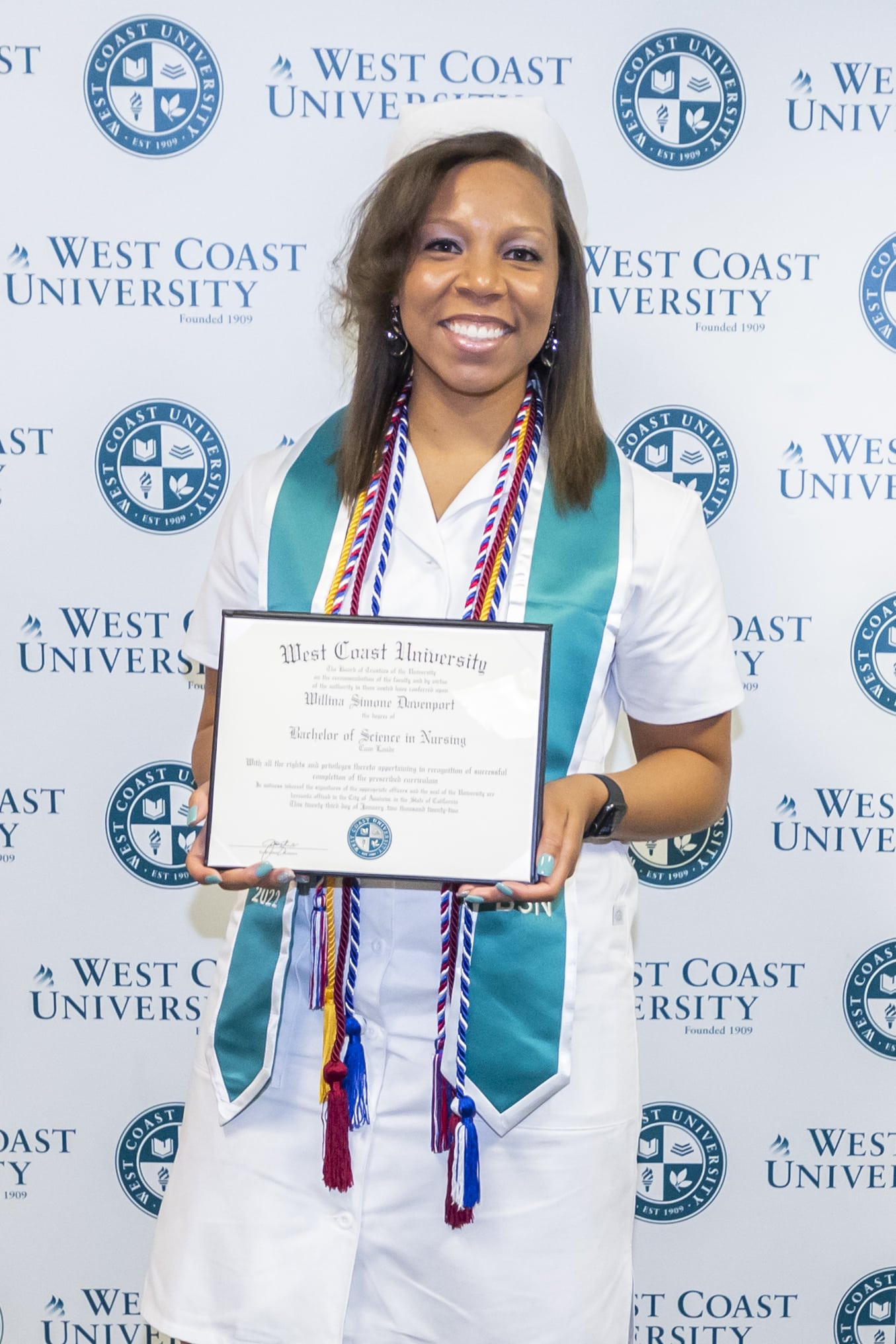 Willina on graduation day holding her diploma
