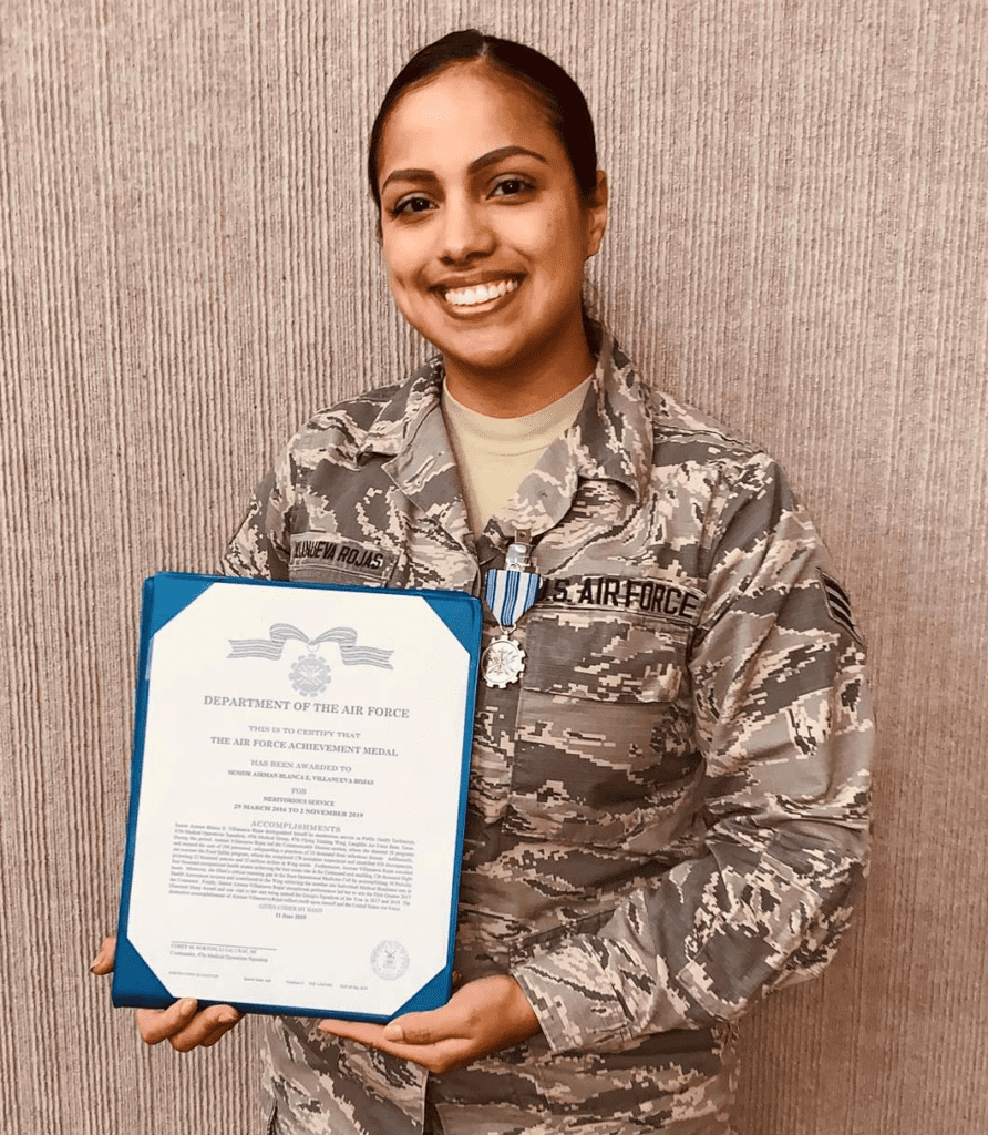 Blanca V. in U.S. Air Force attire holding diploma