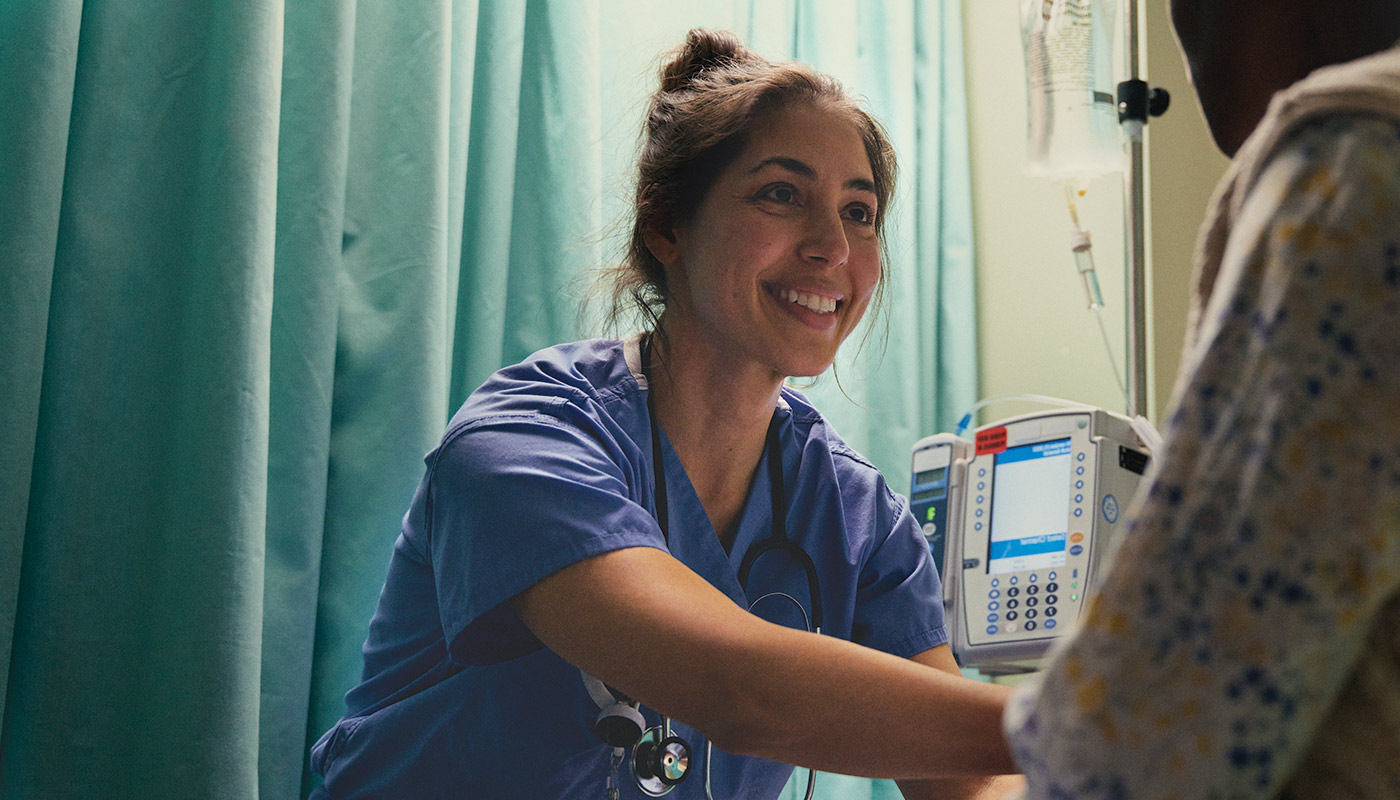 Nurse smiling at a patient.